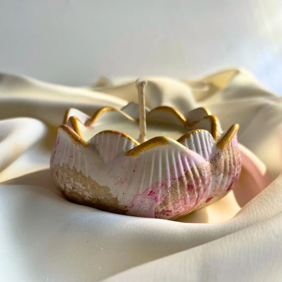 Handmade soy candle in a lotus-designed concrete jar